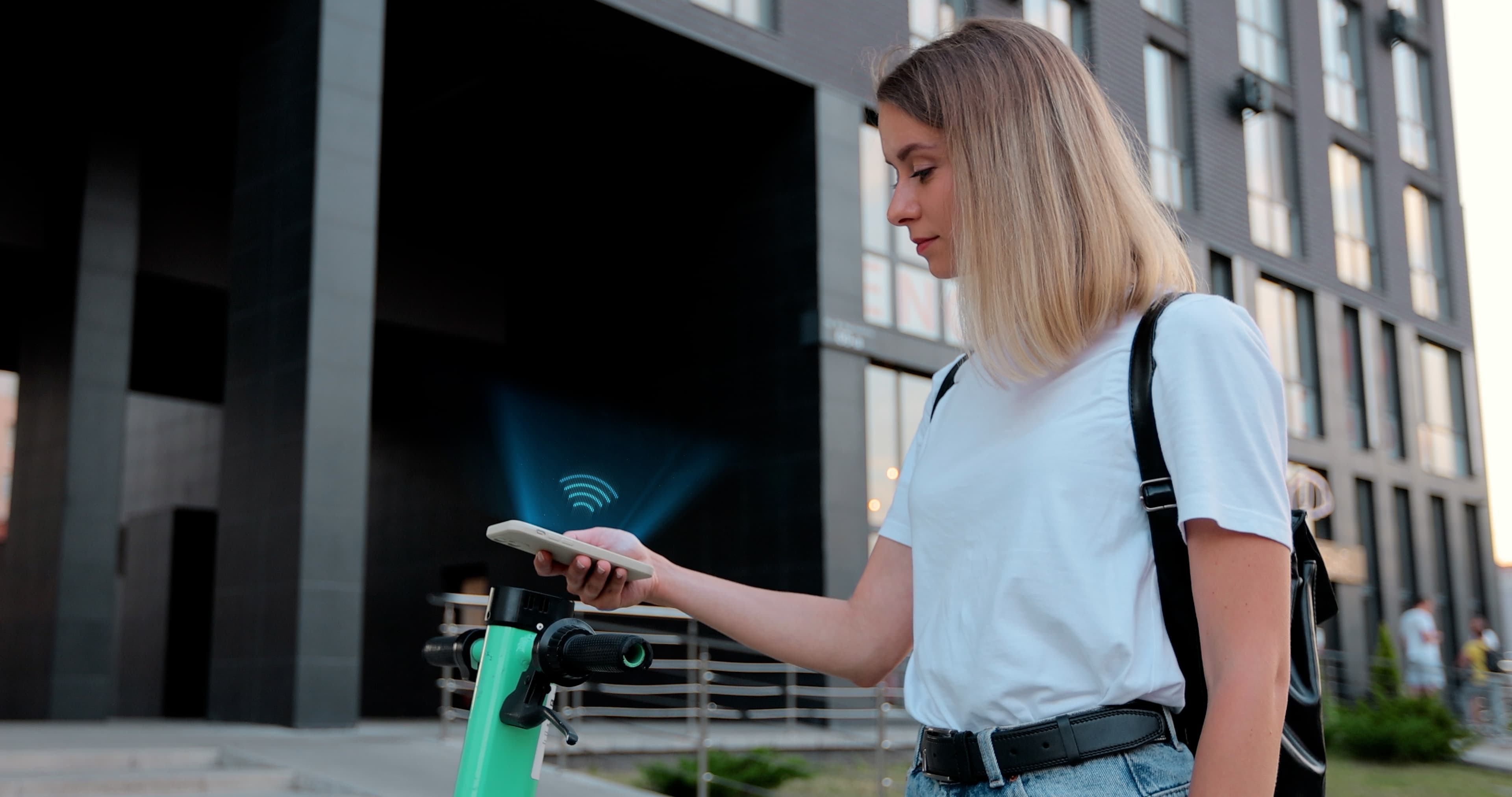 Electric scooter fleet lined up at a charging station in a tourist district