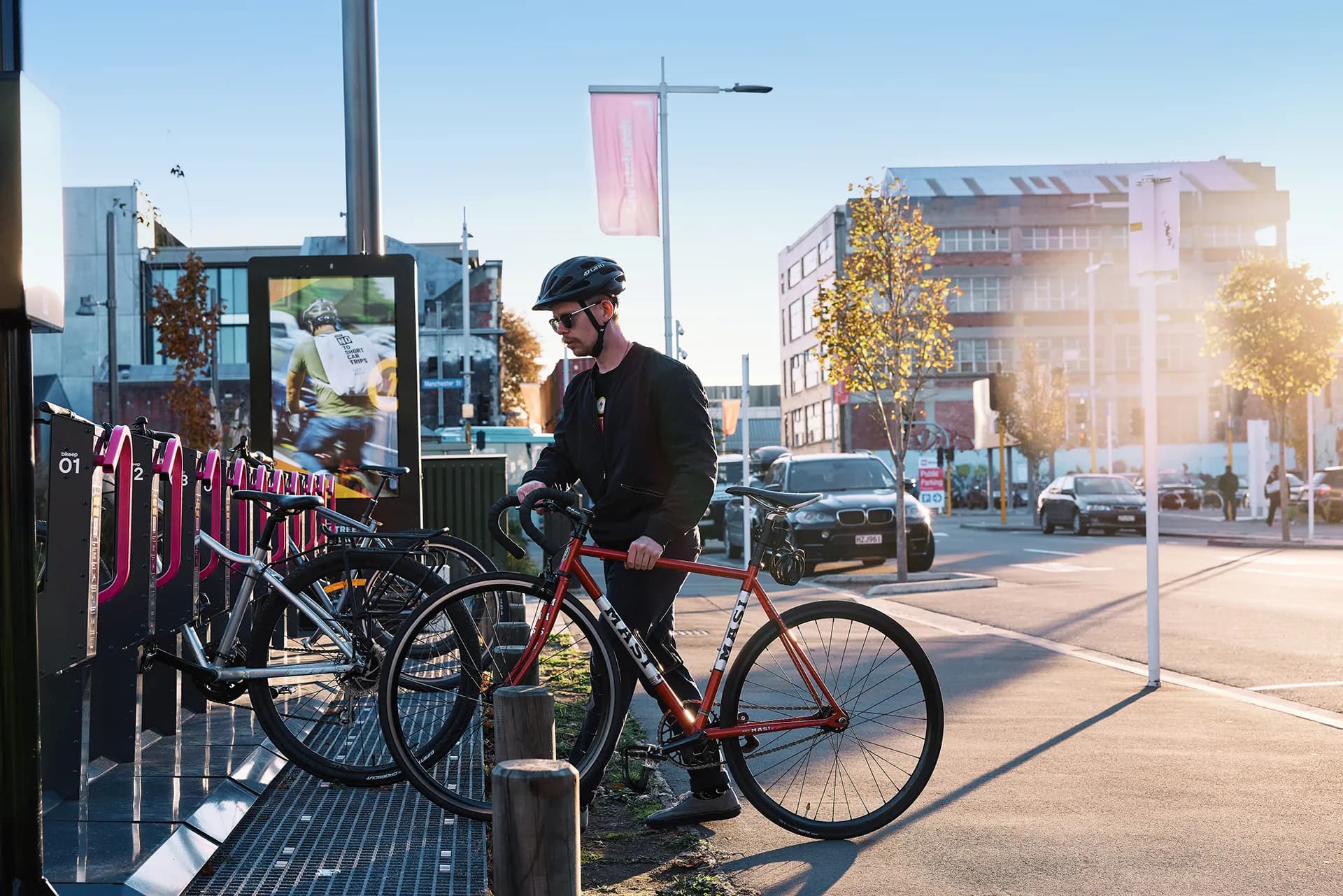 Locky Dock smart bike parking station with secure locking arms and digital advertising screen