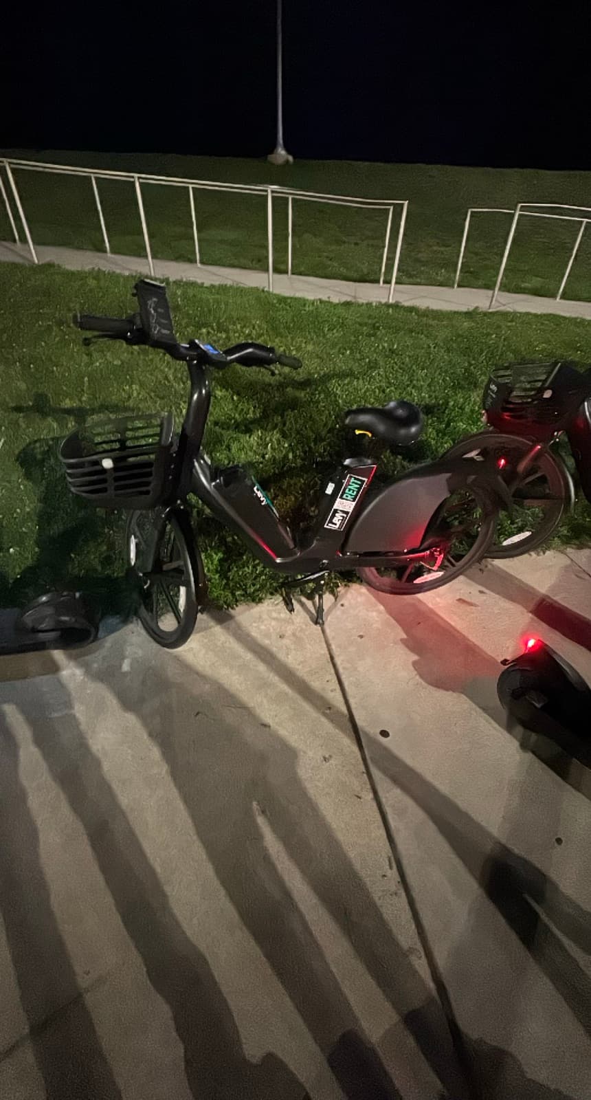 An e-bike left standing on a grass lawn instead of a paved or designated surface