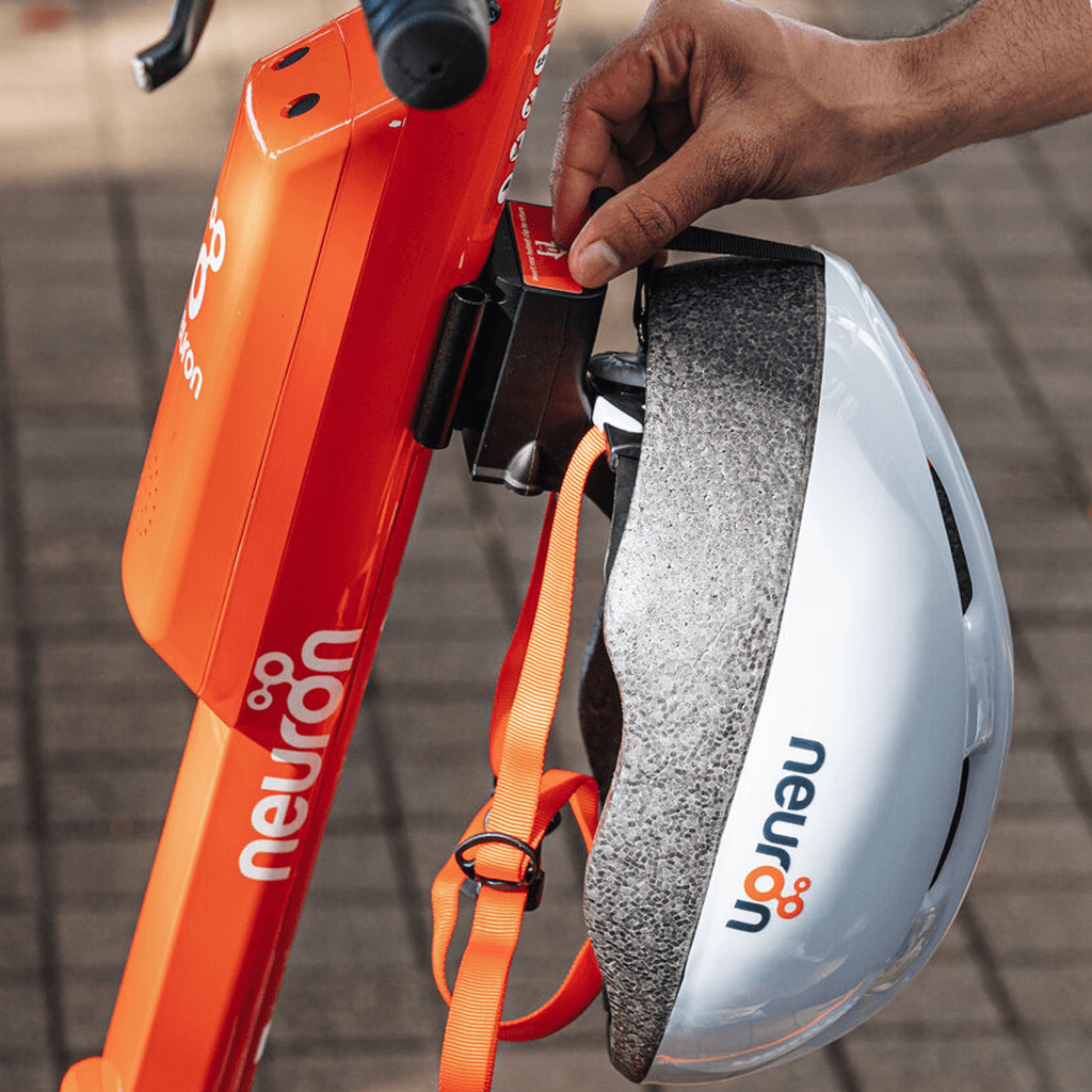 Close-up of a Neuron helmet secured in the scooter helmet lock